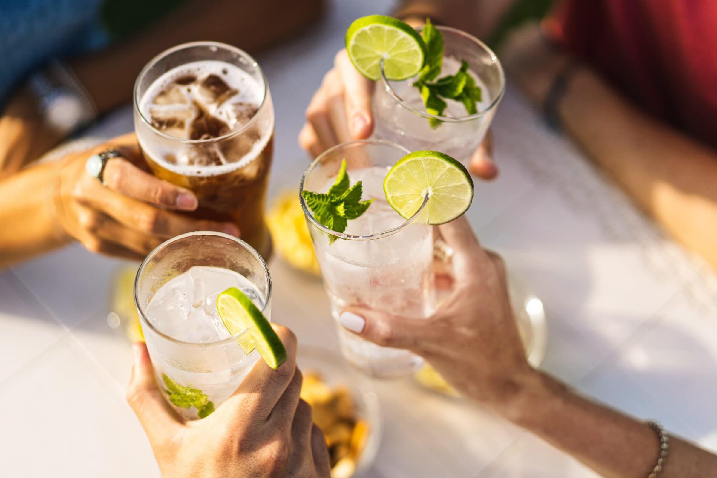 Group,Of,People,Celebrating,Toasting,With,Cocktails,-,Cropped,Detail