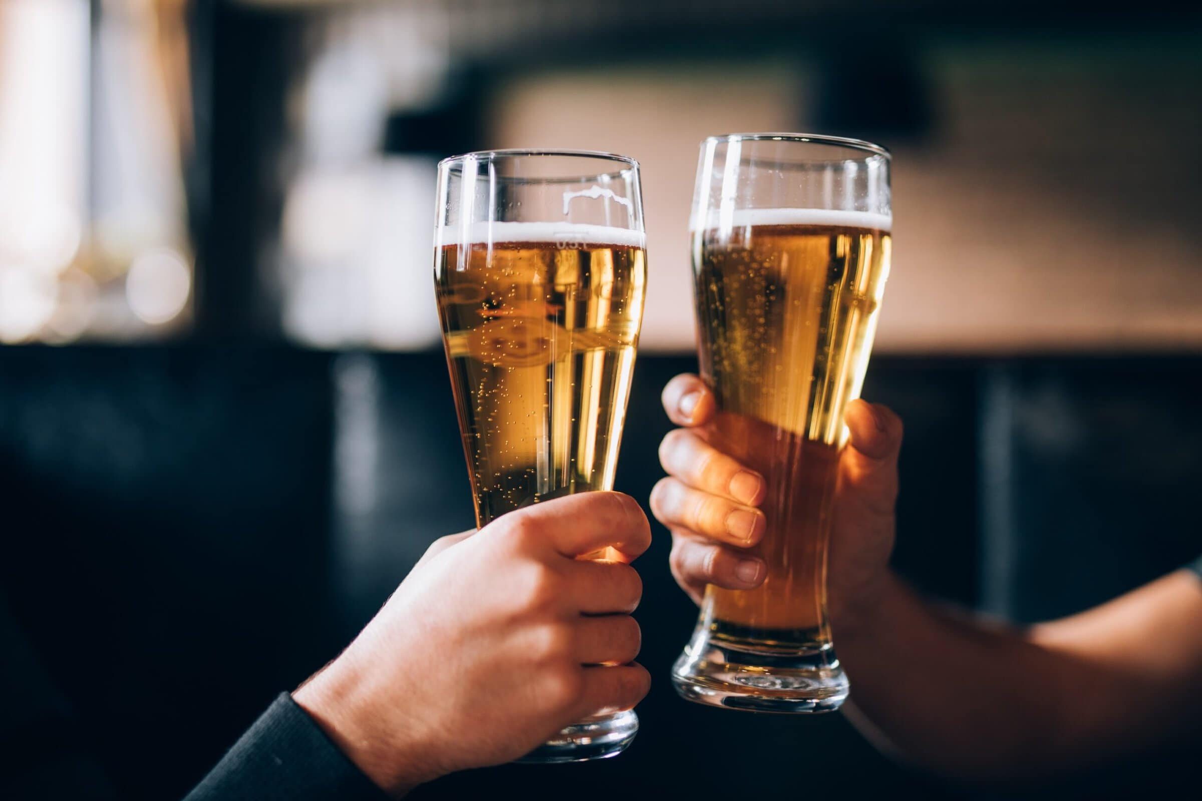 Cheers.,Close-up,Of,Two,Men,In,Shirts,Toasting,With,Beer
